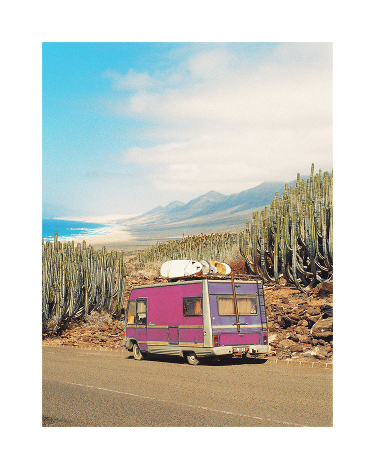 Pink trailer on the road through the dessert towards the ocean coast.